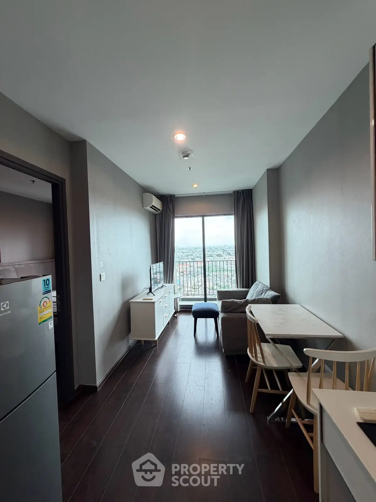 Modern living room with balcony view in high-rise apartment