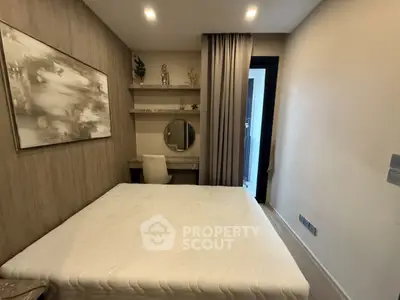 Cozy bedroom with modern decor and built-in shelves, perfect for relaxation and comfort.