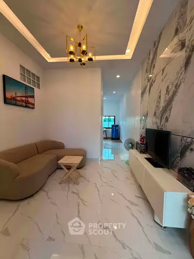 Modern living room with marble accent wall and elegant lighting