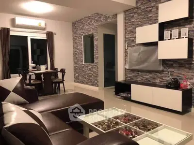 Modern living room with stylish decor and open layout, featuring a cozy seating area and elegant dining space.