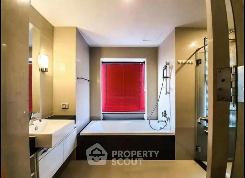 Luxurious bathroom with modern fixtures and large bathtub, featuring elegant design and natural light.