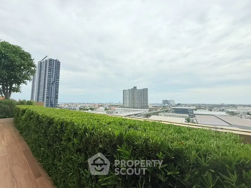 Stunning cityscape view from a lush rooftop garden with modern high-rise buildings.