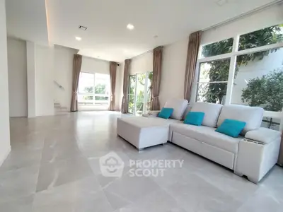 Spacious modern living room with large windows and stylish furniture