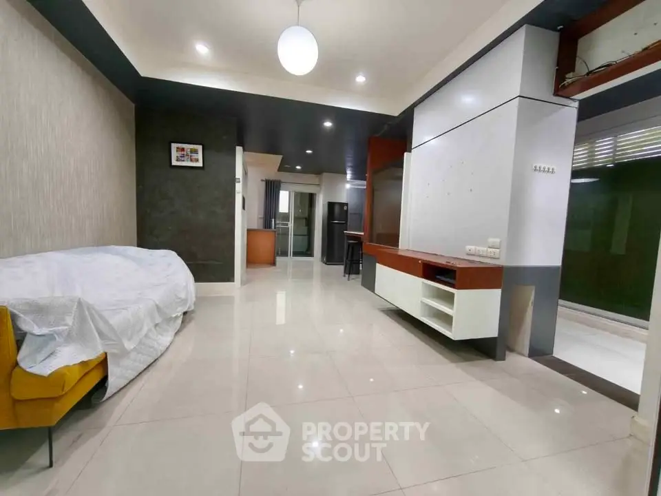 Spacious modern living room with sleek design and ample natural light, perfect for comfortable living.