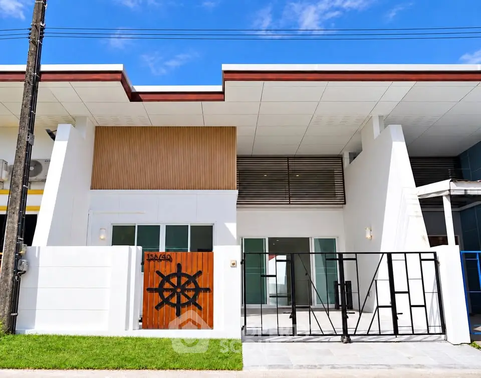 Modern white house with unique wooden gate and sleek exterior design