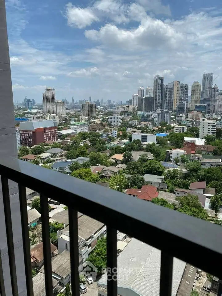 Stunning cityscape view from a high-rise balcony showcasing urban skyline and greenery.
