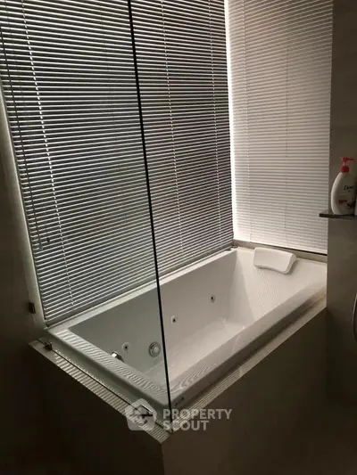 Luxurious bathroom with modern bathtub and sleek blinds