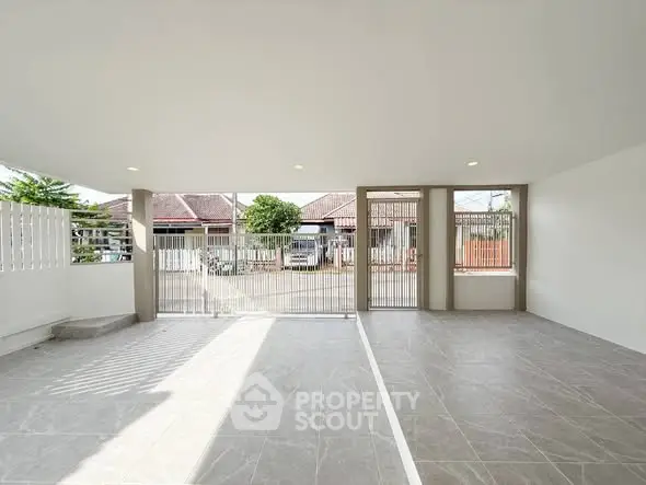Spacious open garage with modern design and ample natural light.