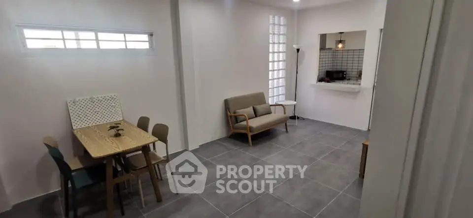 Modern living room with stylish furniture and open kitchen layout