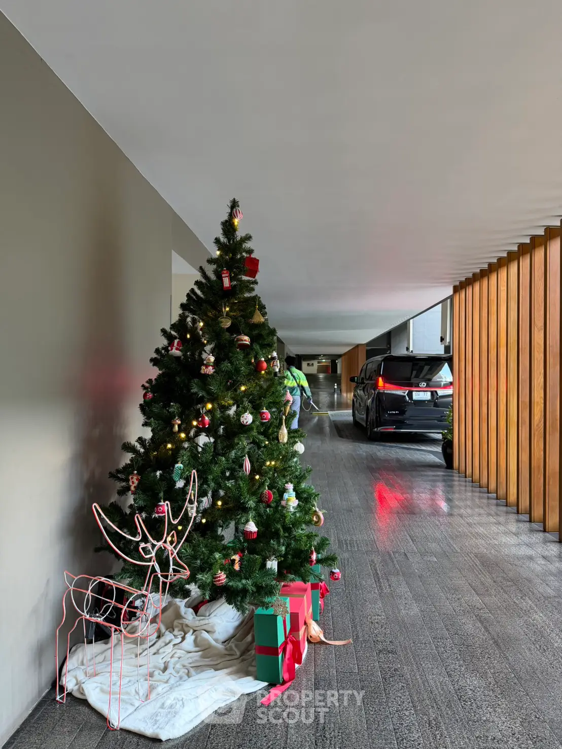 Modern building entrance with festive Christmas tree and decorations