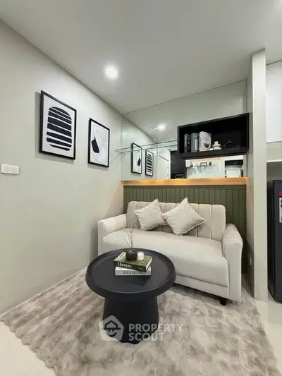Stylish modern living room with cozy sofa, chic decor, and elegant shelving in a compact space.