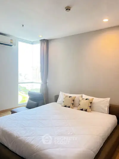 Modern bedroom with large window and cozy bed in a high-rise apartment