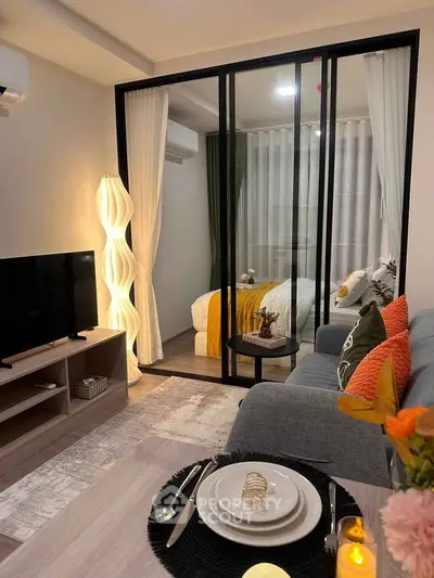 Cozy modern living room with stylish decor and glass partition to bedroom