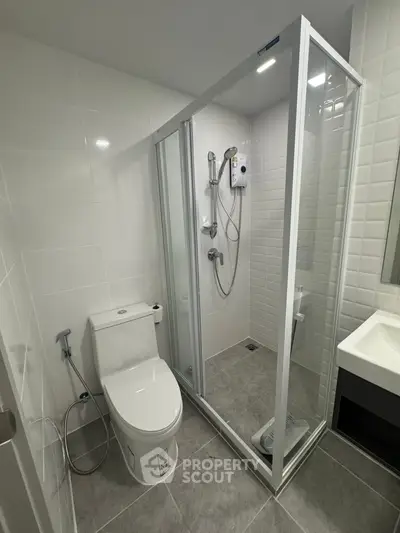 Modern bathroom with glass shower enclosure and sleek fixtures