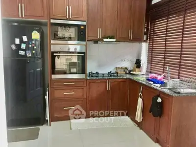 Charming kitchen with wooden cabinets, modern appliances, and natural light.