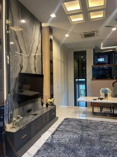 Luxurious modern living room with marble accent wall and stylish decor
