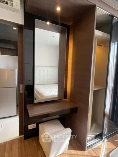 Modern bedroom with stylish vanity and mirrored wardrobe in contemporary apartment