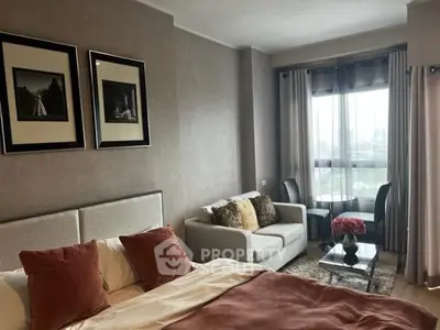 Elegant bedroom with cozy seating area and large window view