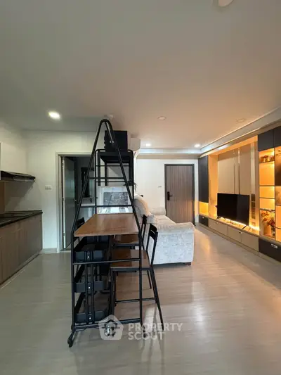 Modern living room with sleek furniture and open kitchen layout