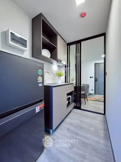 Modern compact kitchen with sleek design and open layout in a stylish apartment.