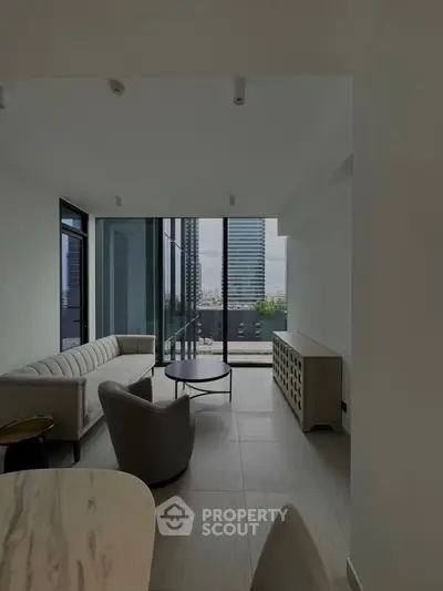 Modern living room with floor-to-ceiling windows offering stunning city views, featuring sleek furniture and minimalist design.