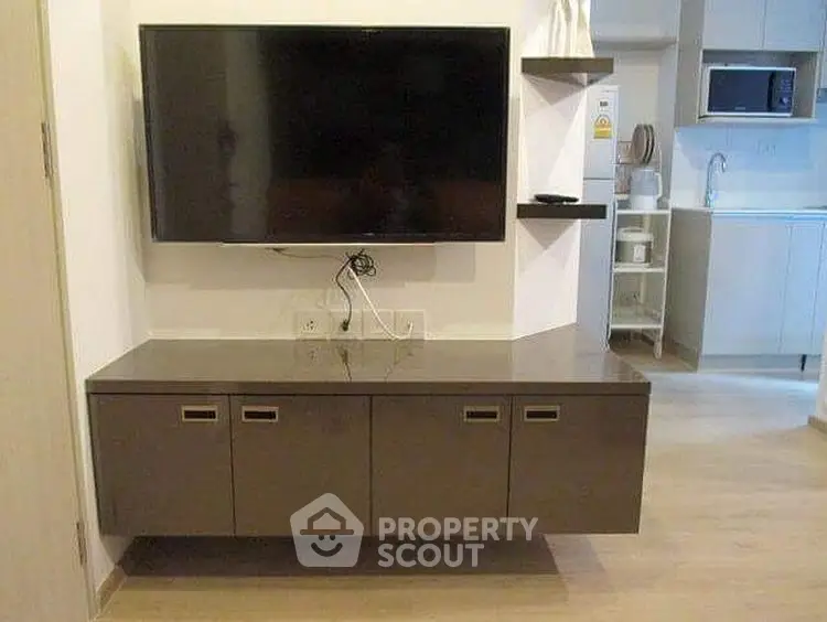 Modern living room with wall-mounted TV and sleek cabinetry