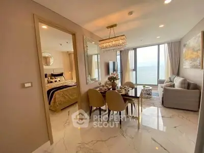 Luxurious open-plan living and dining area with ocean view in modern apartment.