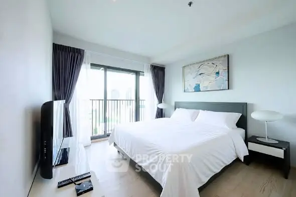 Spacious modern bedroom with balcony view in luxury apartment