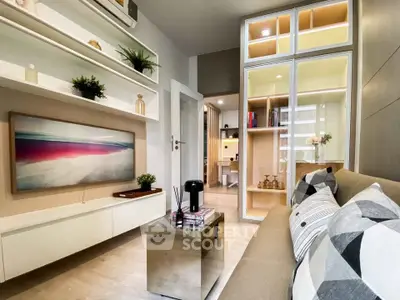 Modern living room with stylish decor and open shelving, featuring a cozy seating area and elegant design.