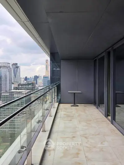 Spacious balcony with stunning city skyline view, perfect for relaxation and entertainment.