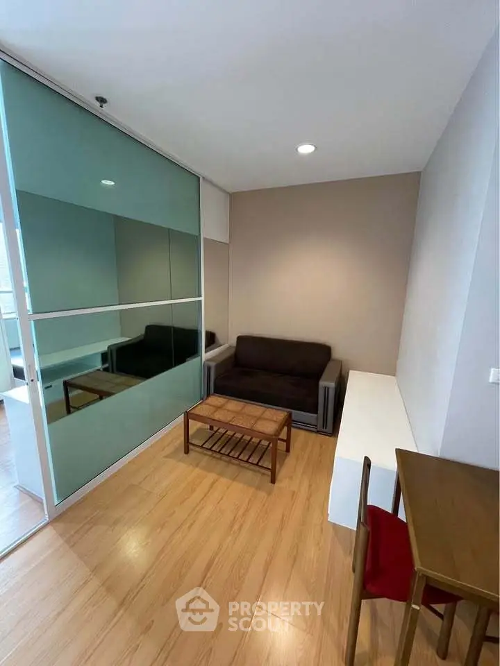 Cozy living room with modern furniture and wooden flooring in a stylish apartment.