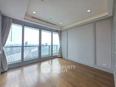 Spacious corner unit with panoramic city views and elegant wood flooring.