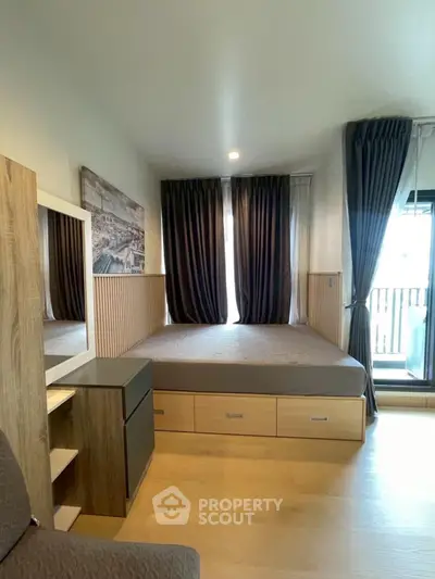 Modern bedroom with large windows and stylish wooden furniture