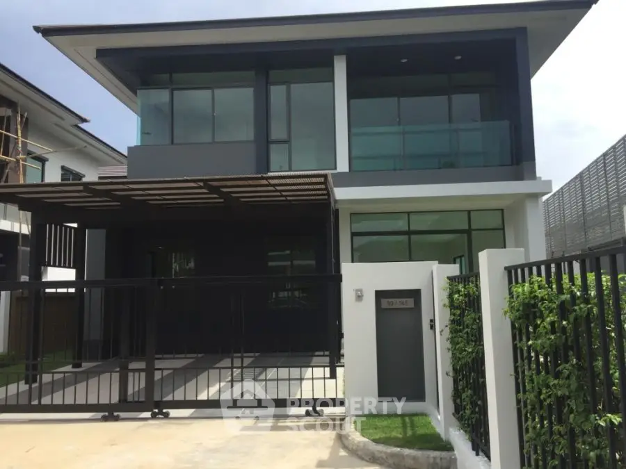 Modern two-story house with sleek design and spacious driveway in a serene neighborhood.