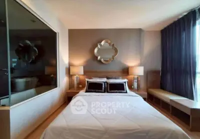 Modern bedroom with stylish decor and large window for natural light