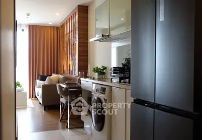 Modern open-layout kitchen with sleek appliances and cozy living area, perfect for urban living.