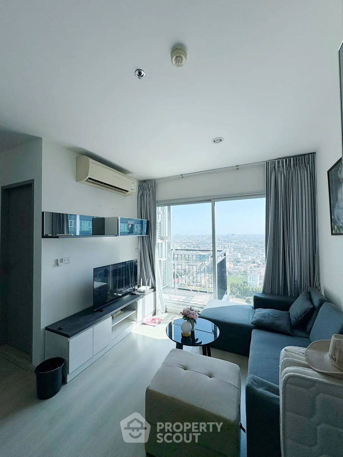 Modern living room with panoramic city view and stylish furnishings