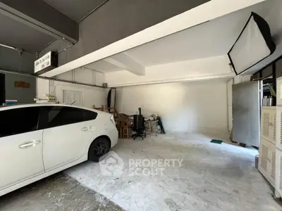 Spacious garage with ample storage space and parked car in modern residential property
