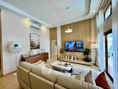 Luxurious living room with modern decor, large windows, and stylish furniture in a contemporary home.