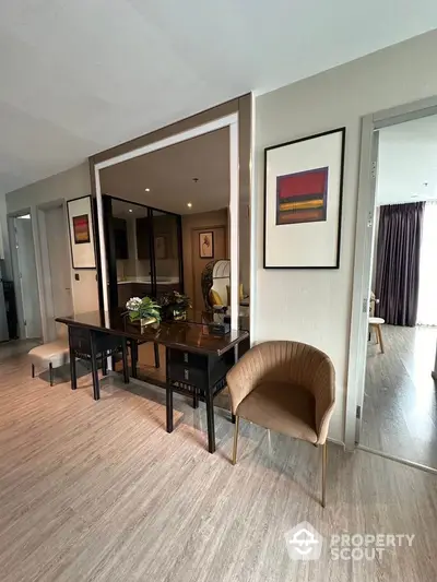 Modern apartment interior with stylish decor and open layout, featuring elegant furniture and artwork.