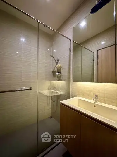 Modern bathroom with glass shower enclosure and sleek vanity