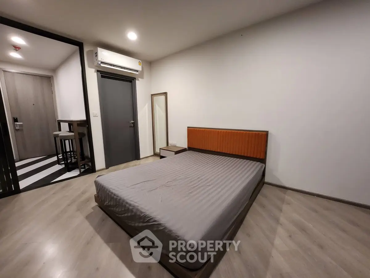 Spacious modern bedroom with minimalist design and wooden flooring