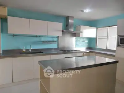Modern kitchen with sleek stainless steel countertops and open layout