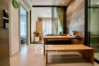 Modern living room with wooden furniture and sliding glass doors in a stylish apartment.