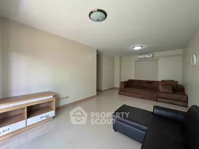 Spacious living room with modern furniture and neutral tones, perfect for relaxation and entertainment.