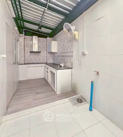 Spacious kitchen with modern fixtures and ample natural light, perfect for culinary enthusiasts.