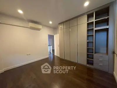 Spacious bedroom with sleek built-in wardrobe and modern lighting