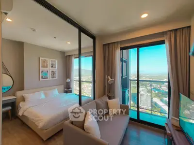 Luxurious bedroom with stunning city view and modern decor in high-rise apartment.