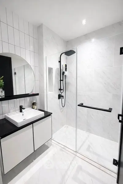 Modern bathroom with sleek shower and stylish vanity in contemporary design.