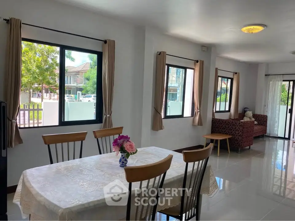 Spacious dining area with natural light and garden view, perfect for family gatherings.